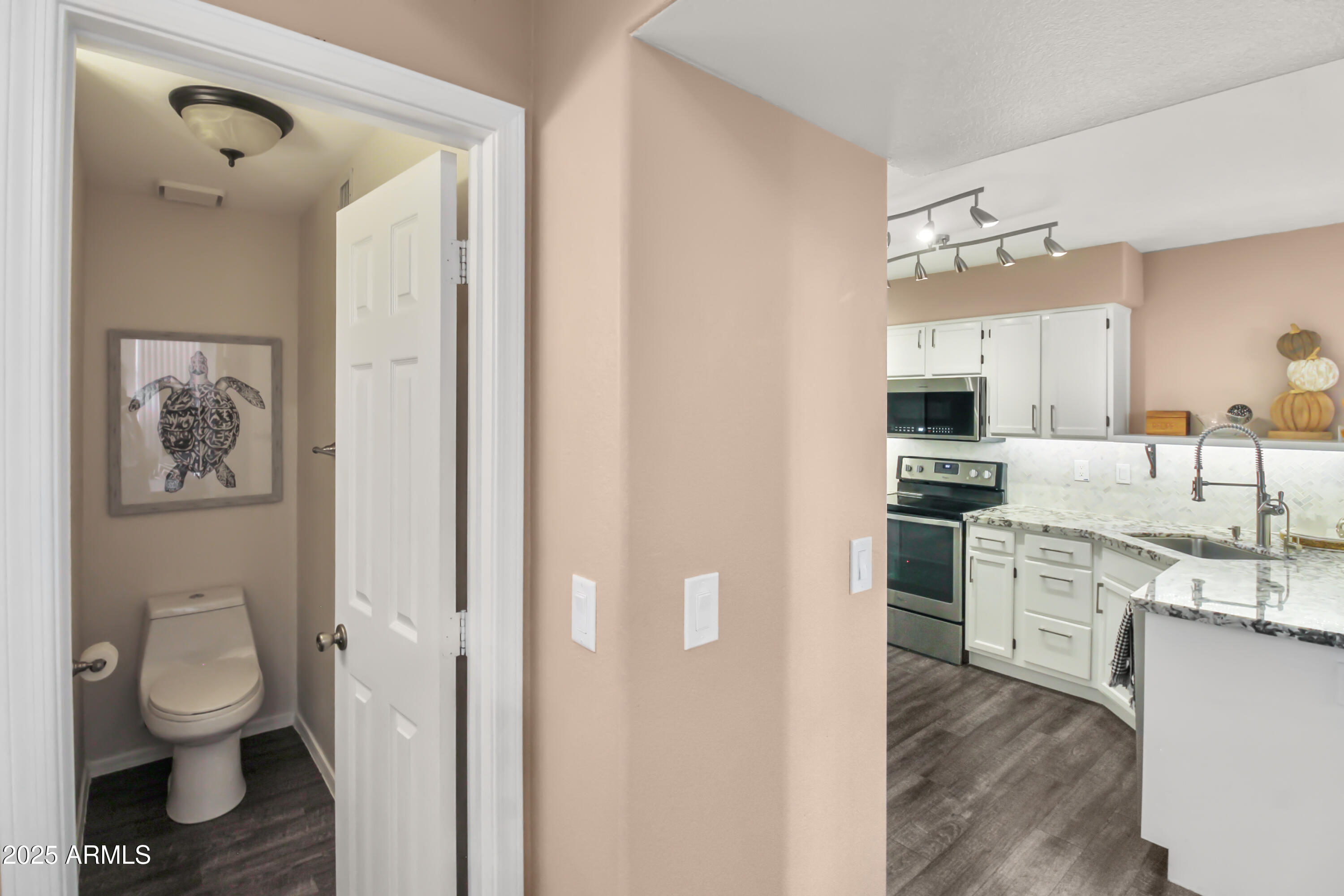 1122 West Sandy Banks Gilbert, AZ 85233 - Photo 12 of 22 a kitchen with white cabinets and stainless steel appliances