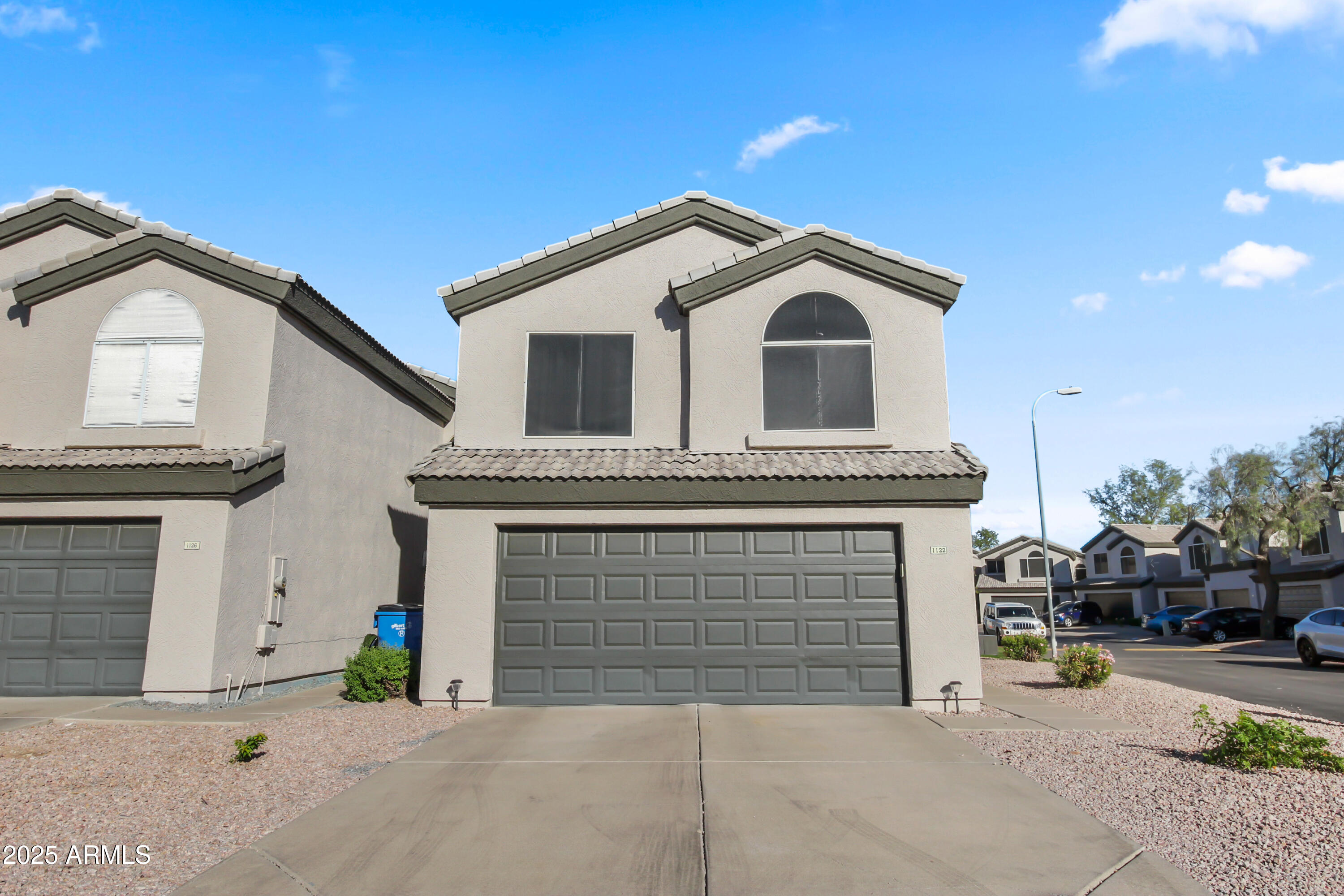 1122 West Sandy Banks Gilbert, AZ 85233 - Photo 2 of 22 a front view of a house with a garage