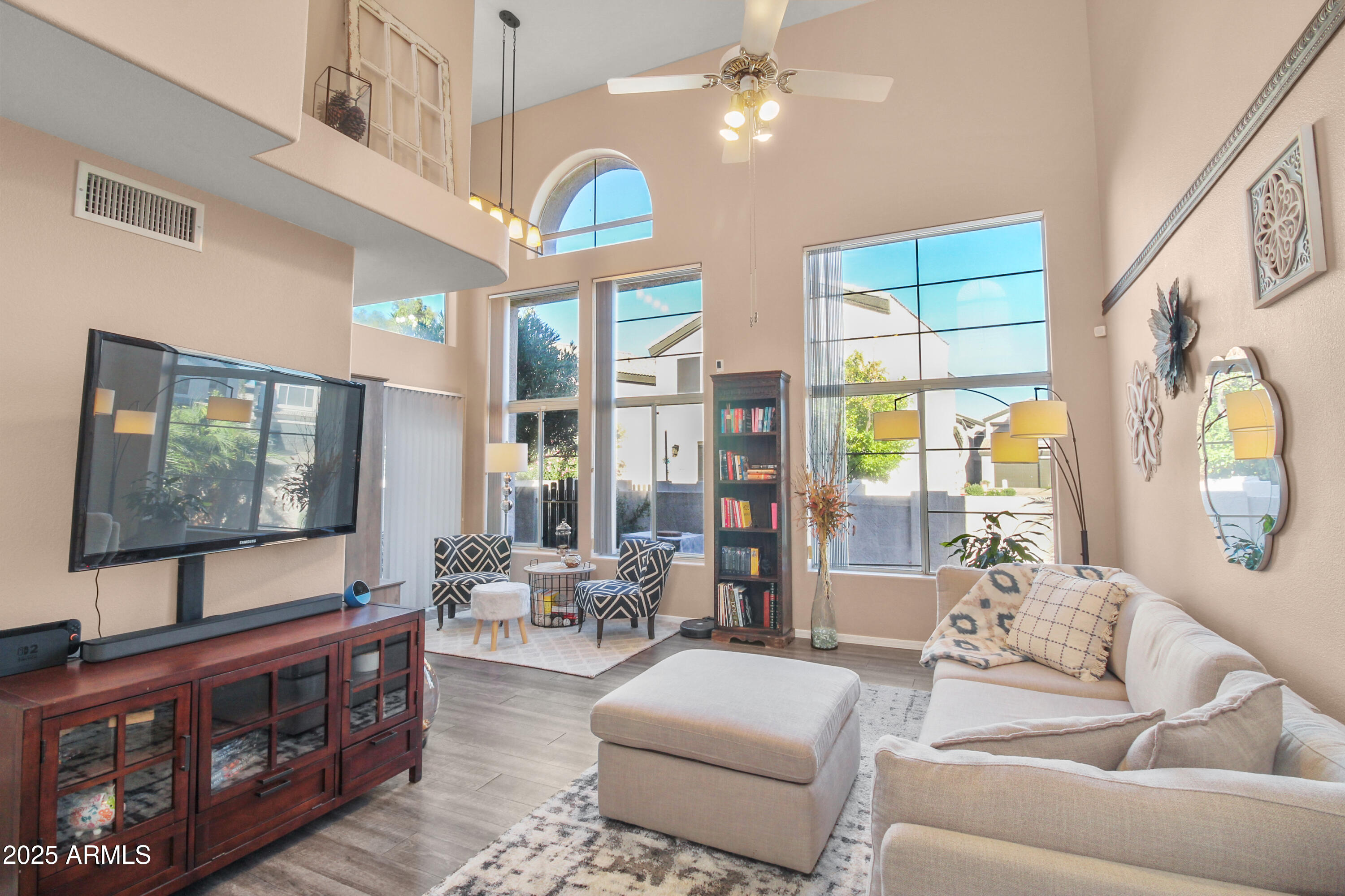 1122 West Sandy Banks Gilbert, AZ 85233 - Photo 5 of 22 a living room with furniture a large window and a flat screen tv