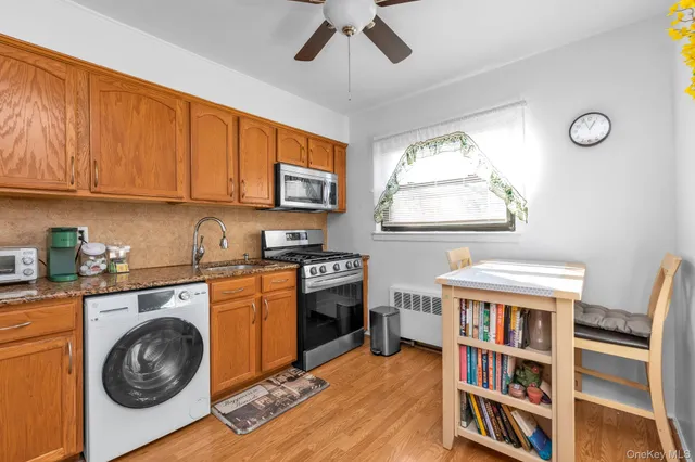 a kitchen with stainless steel appliances a white cabinets and a stove top oven
