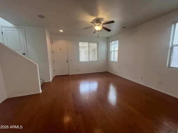 a view of wooden floor and windows in a room
