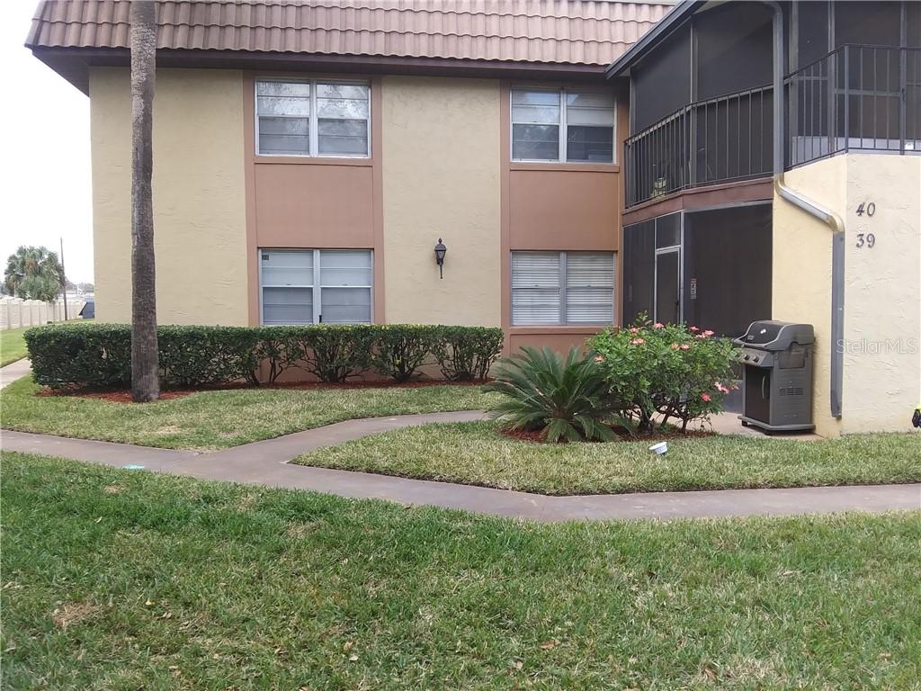 39 Windtree Lane, Unit 104 Winter Garden, FL 34787 - Photo 1 of 1 a front view of a house with a yard