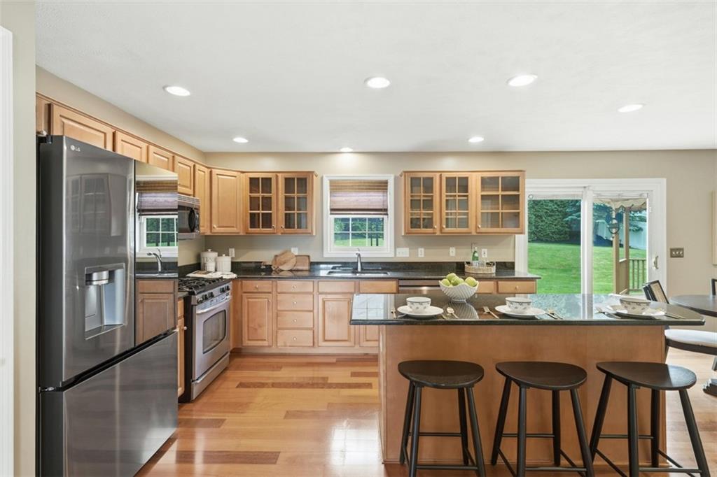 4003 Oak Point Circle McKees Rocks, PA 15136 - Photo 19 of 50 The expansive kitchen layout offers excellent storage, generous prep surfaces, and multiple seating areas that support both casual meals and entertaining. Open-concept design keeps the kitchen fully connected to the home’s primary living spaces while maintaining great everyday usability.
