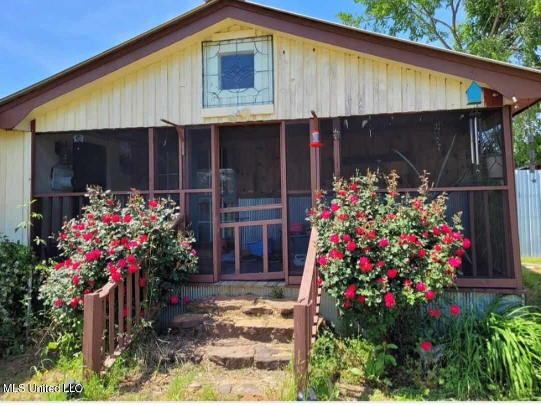 938 Frank Smith Road Batesville, MS 38606 - Photo 11 of 62 Front of Home with Blooming Bushes