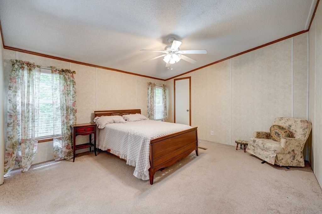 150 Hickory Hls Road Ellijay, GA 30540 - Photo 13 of 24 a bedroom with a bed and a chandelier