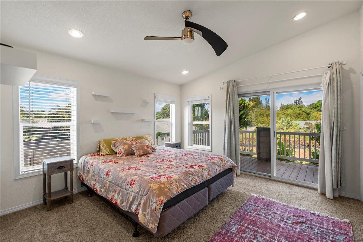 943 Kokomo Road Haiku, HI 96708 - Photo 14 of 50 a bedroom with a large bed and a window