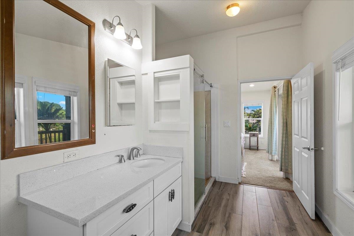 943 Kokomo Road Haiku, HI 96708 - Photo 18 of 50 a bathroom with a sink a mirror and a shower