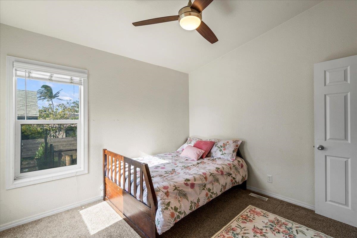 943 Kokomo Road Haiku, HI 96708 - Photo 23 of 50 a bedroom with a bed and window