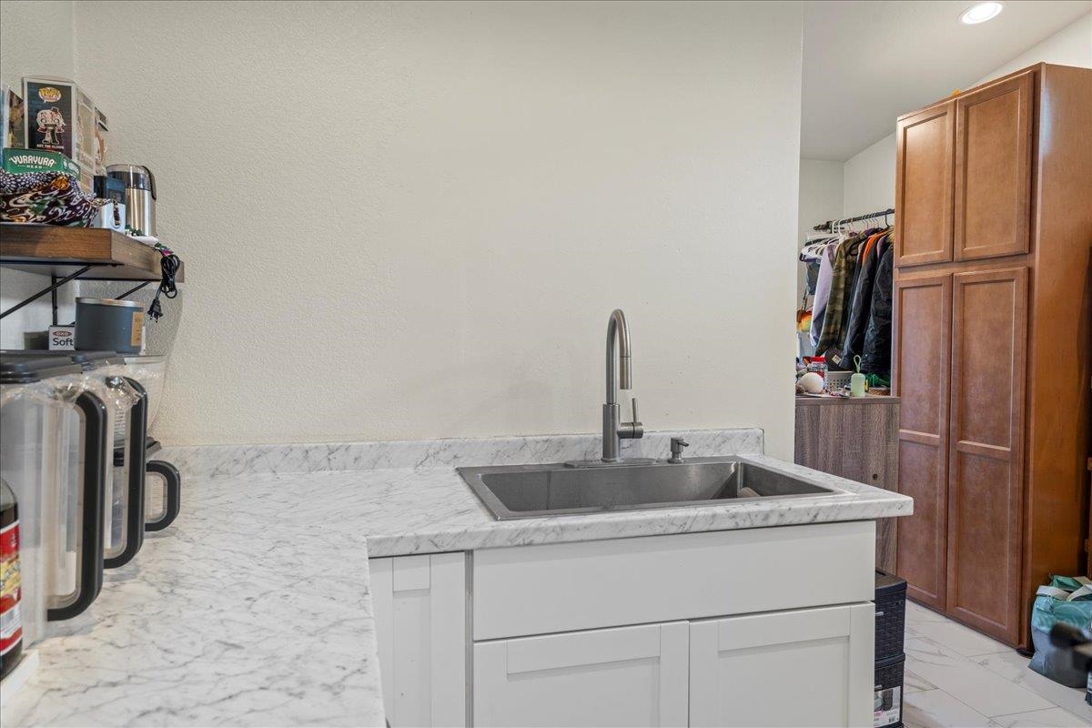 943 Kokomo Road Haiku, HI 96708 - Photo 31 of 50 a kitchen with a sink and a refrigerator