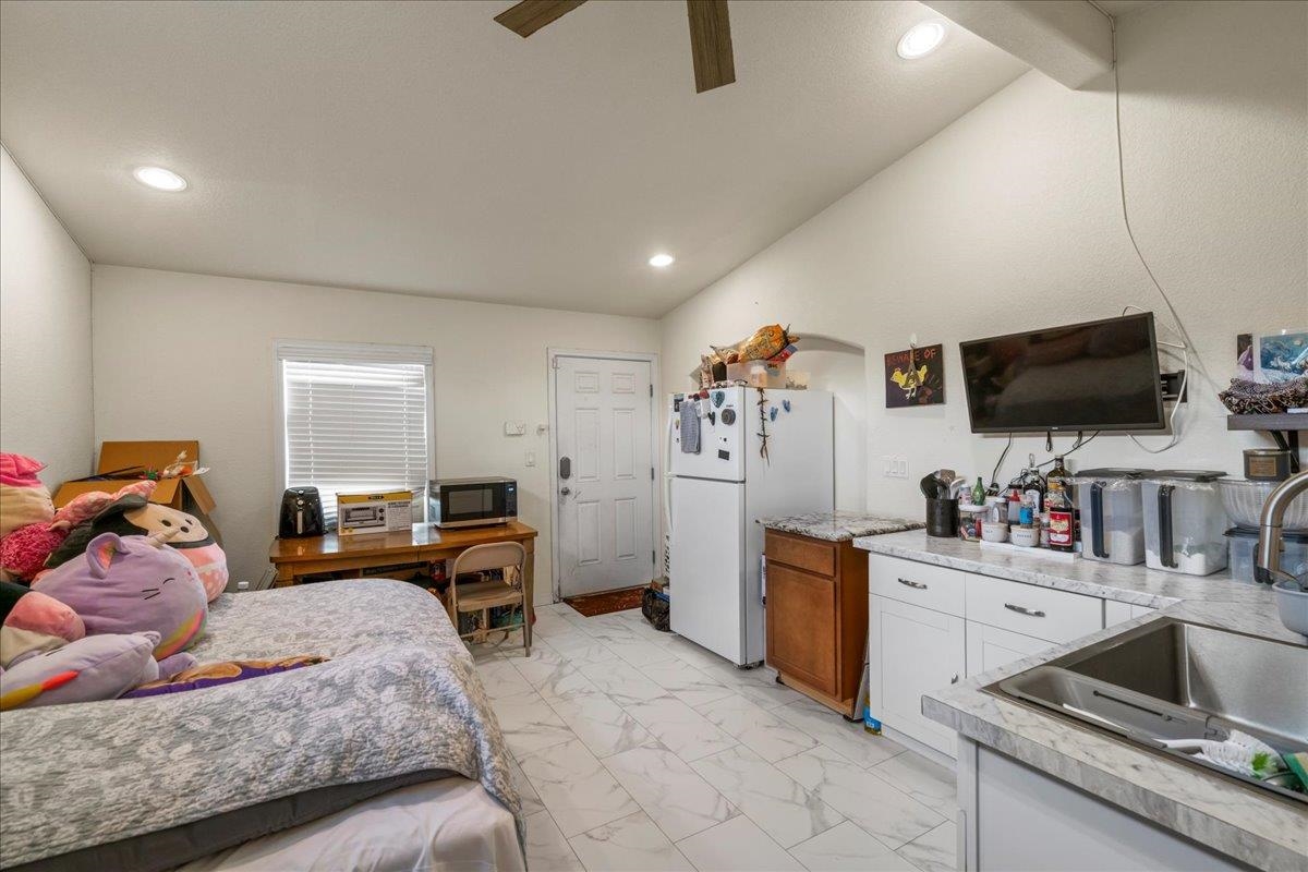 943 Kokomo Road Haiku, HI 96708 - Photo 33 of 50 a bedroom with furniture and a flat screen tv