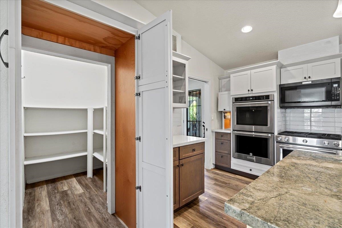 943 Kokomo Road Haiku, HI 96708 - Photo 10 of 50 a kitchen with a refrigerator and a stove top oven