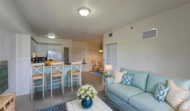 a living room with lots of furniture and kitchen view