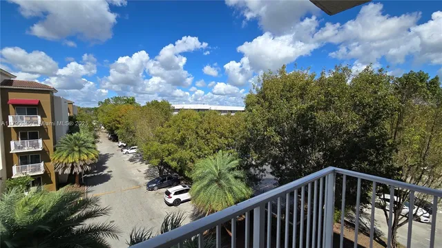 a balcony with wooden floor and city view