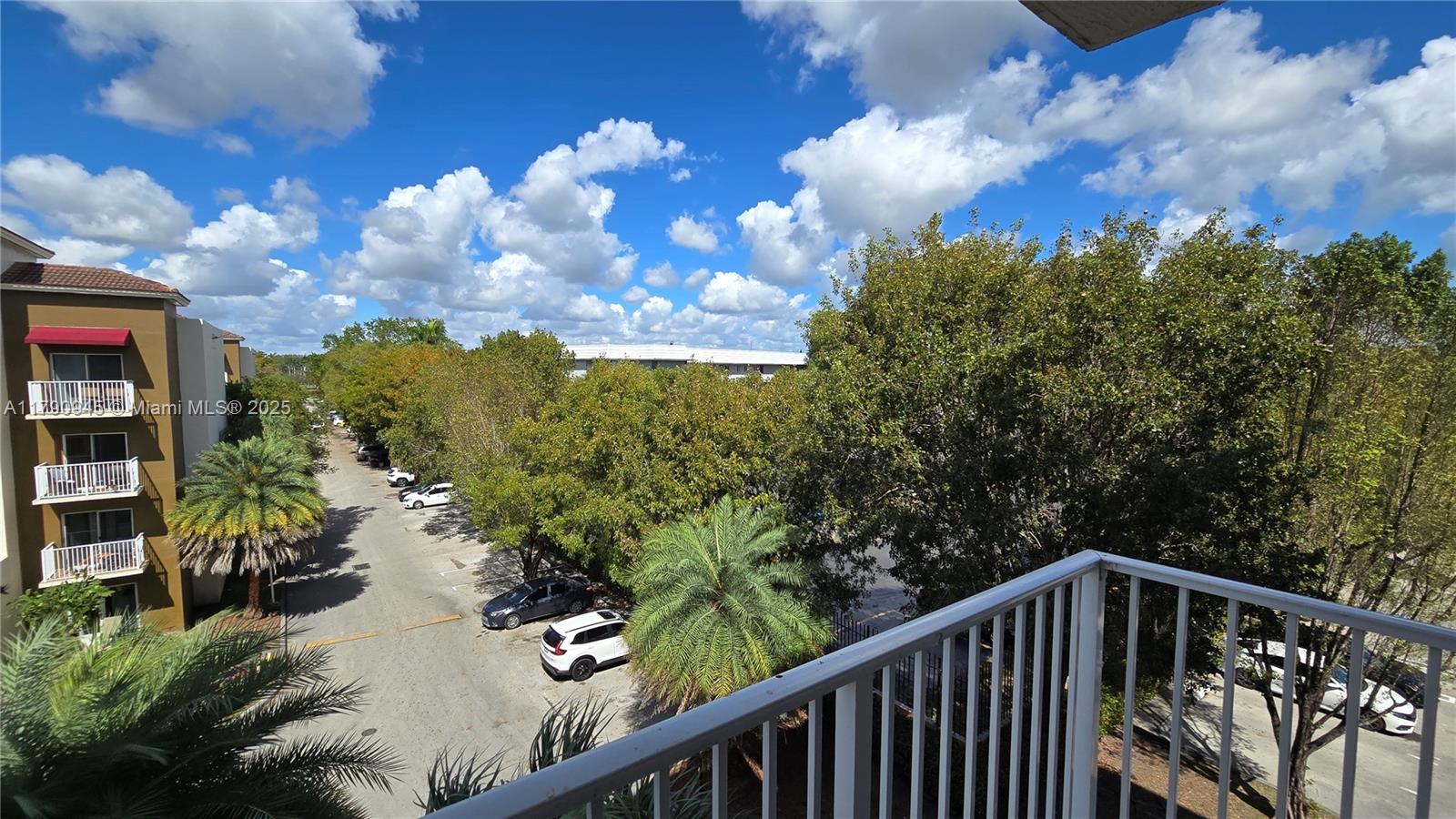 11060 Southwest 196th Street, Unit 407 Cutler Bay, FL 33157 - Photo 12 of 25 a balcony with wooden floor and city view