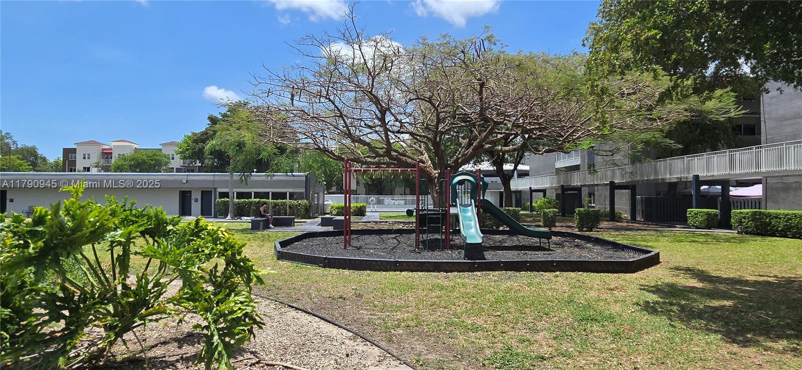 11060 Southwest 196th Street, Unit 407 Cutler Bay, FL 33157 - Photo 20 of 25 a front view of a house with a yard fountain and outdoor seating