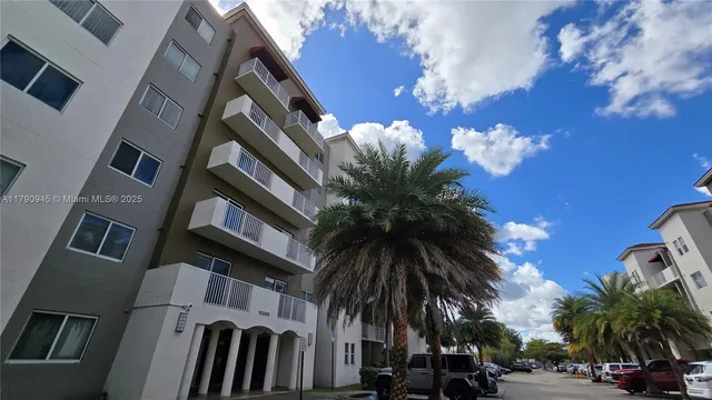 a view of multiple house with a yard and palm trees