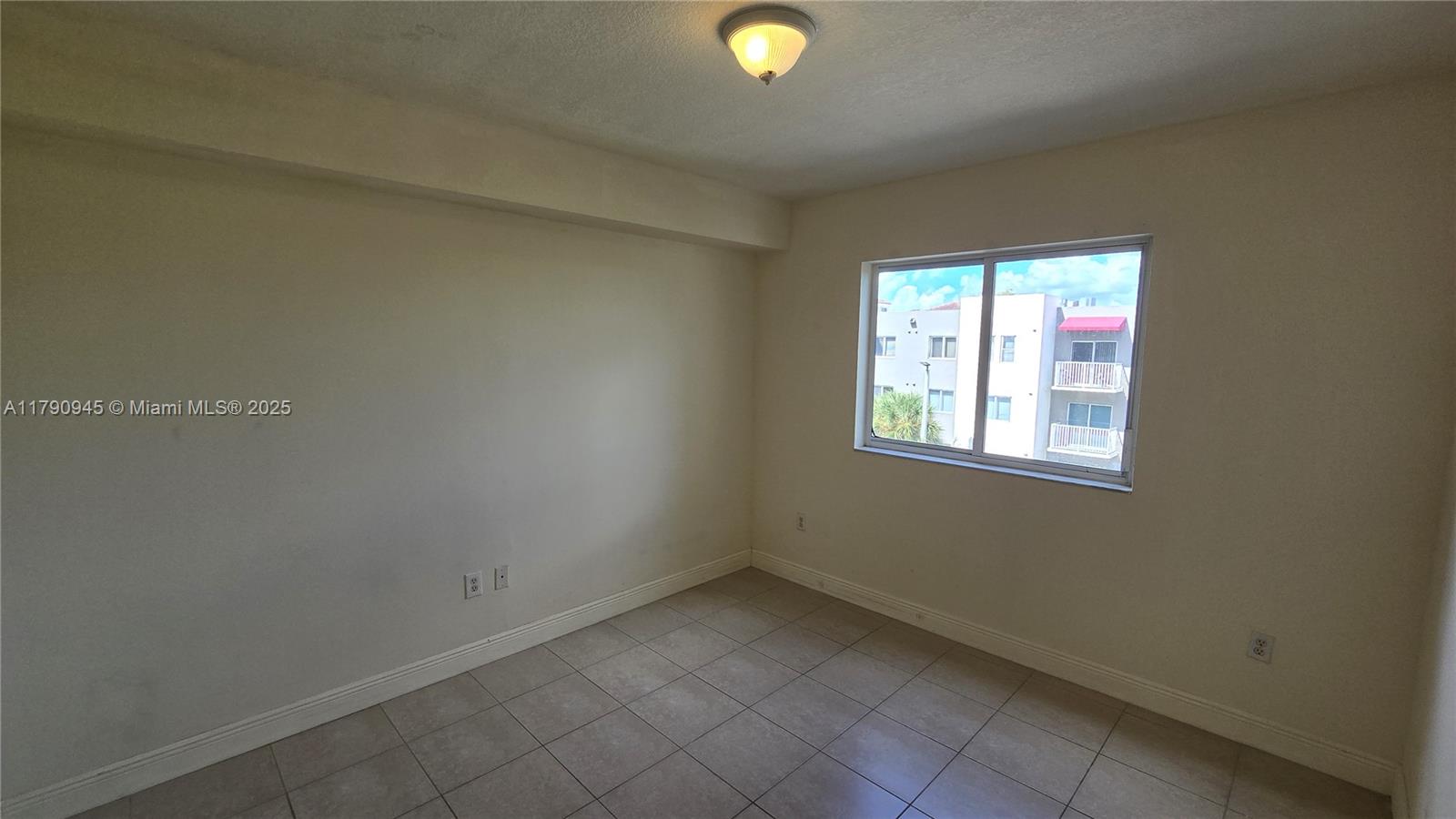 11060 Southwest 196th Street, Unit 407 Cutler Bay, FL 33157 - Photo 4 of 25 an empty room with windows