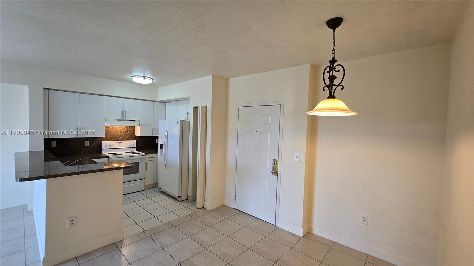 11060 Southwest 196th Street, Unit 407 Cutler Bay, FL 33157 - Photo 10 of 25 a kitchen with stainless steel appliances a refrigerator and a sink