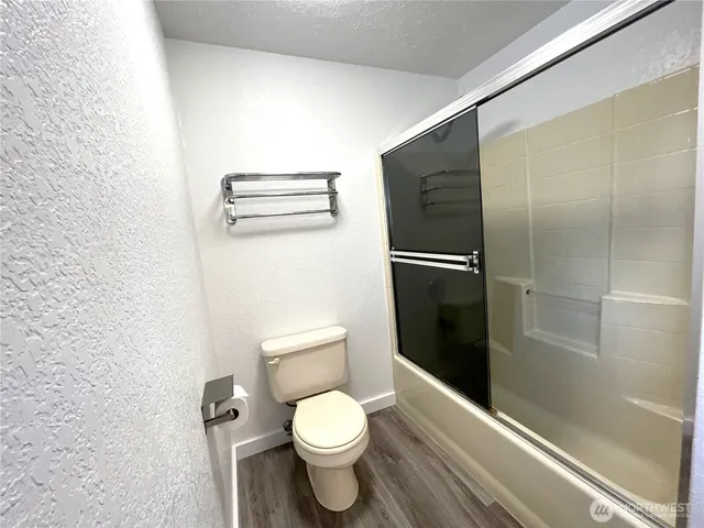 a bathroom with a toilet and a shower