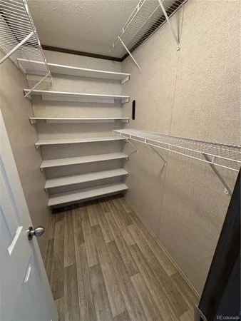a view of walk in closet with empty racks