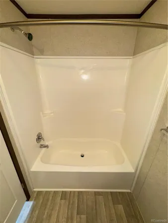a bathroom with a shower and a bath tub