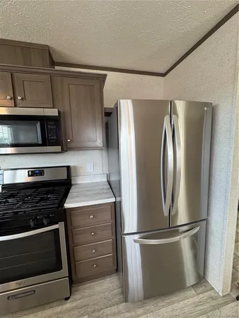 a kitchen with appliances and a refrigerator