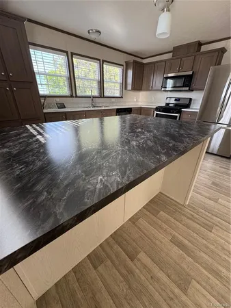 a view of kitchen with granite countertop window