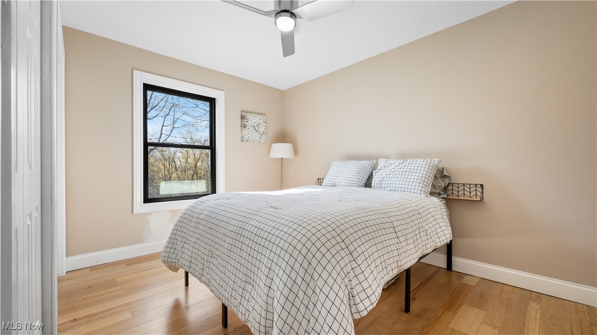 8410 Shepard Road Macedonia, OH 44056 - Photo 22 of 34 Bedroom featuring wood finished floors, a ceiling fan, and baseboards