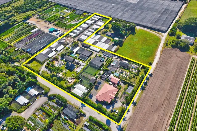 a view of a house with a yard and potted plants