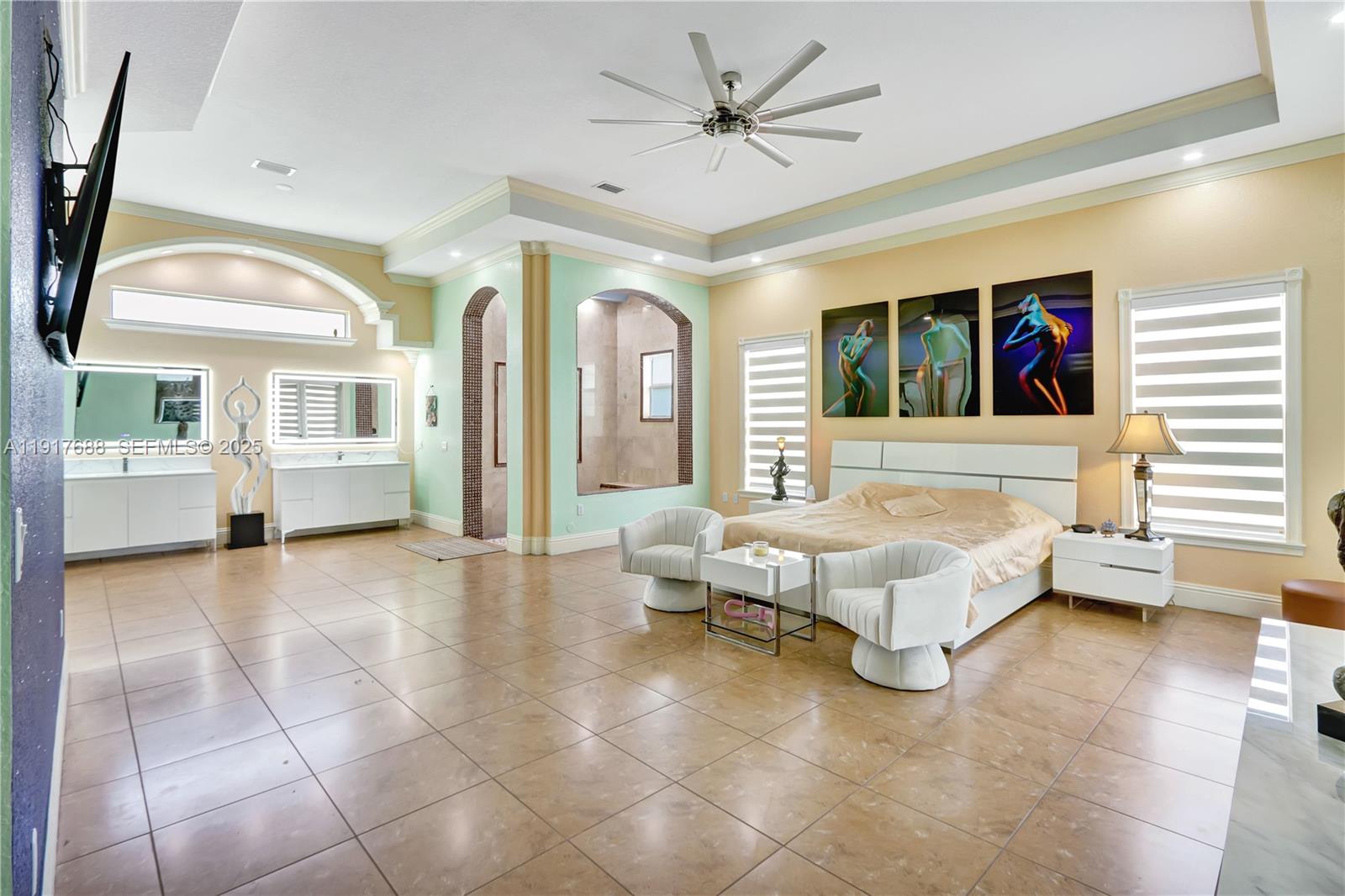 20455 Southwest 154th Avenue Miami, FL 33187 - Photo 17 of 95 a spacious bedroom with a large bed a chandelier and windows