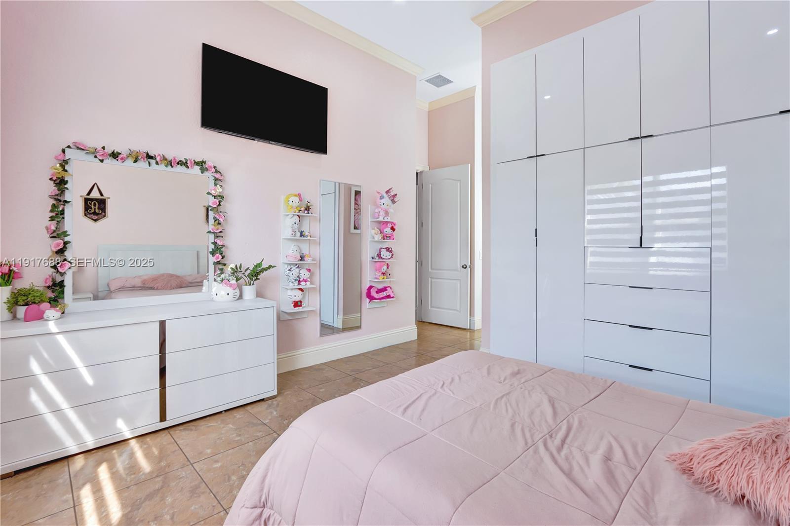 20455 Southwest 154th Avenue Miami, FL 33187 - Photo 25 of 95 a bedroom with a bed and flat screen tv