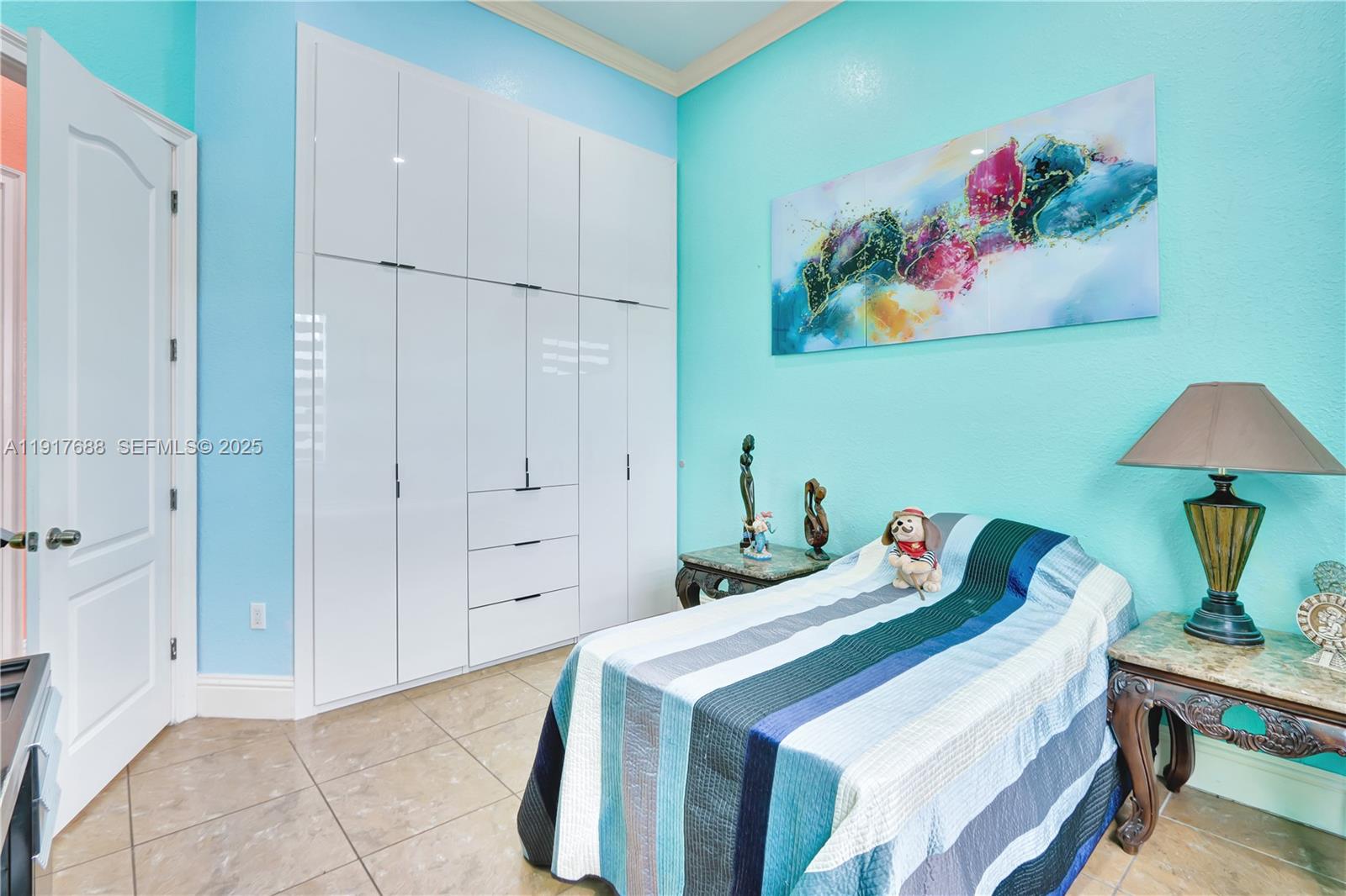 20455 Southwest 154th Avenue Miami, FL 33187 - Photo 29 of 95 a bedroom with a bed and a painting on the wall