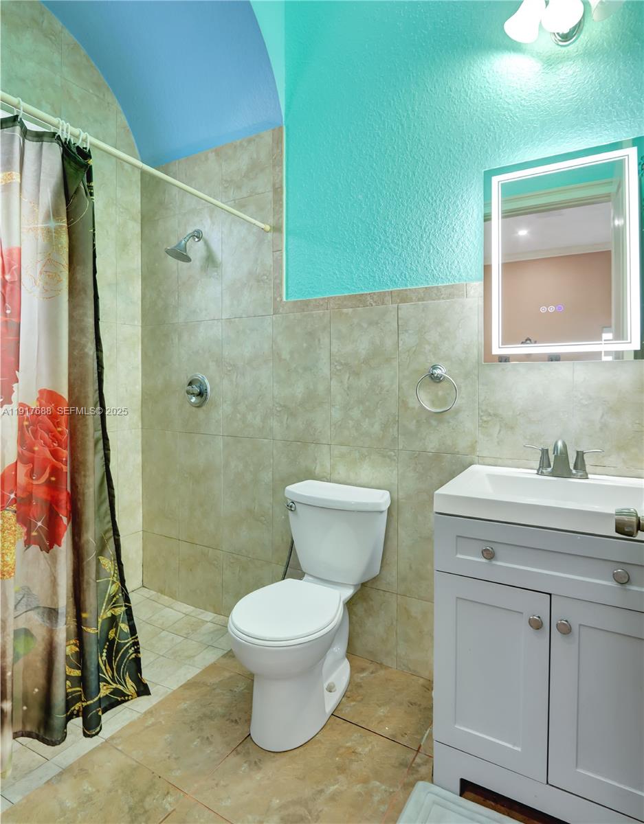 20455 Southwest 154th Avenue Miami, FL 33187 - Photo 36 of 95 a bathroom with a sink a toilet and shower