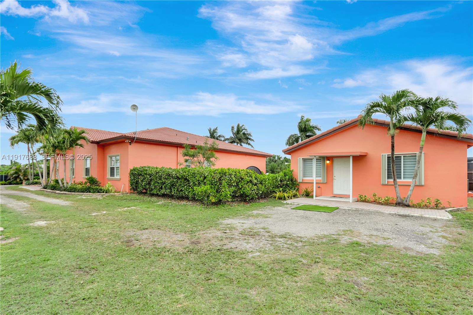 20455 Southwest 154th Avenue Miami, FL 33187 - Photo 41 of 95 a front view of a house with a yard and potted plants