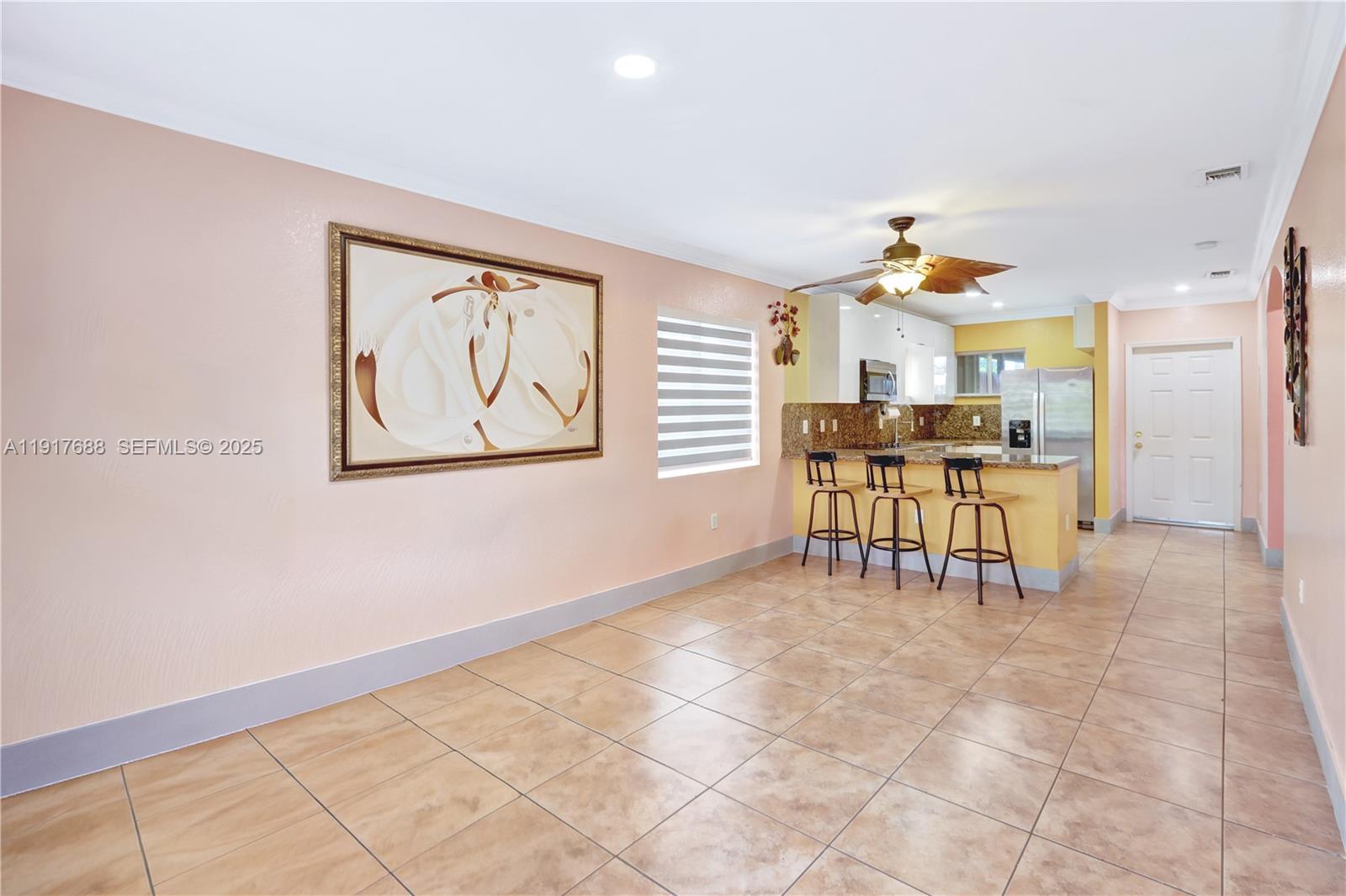 20455 Southwest 154th Avenue Miami, FL 33187 - Photo 42 of 95 a view of a livingroom with furniture and a kitchen