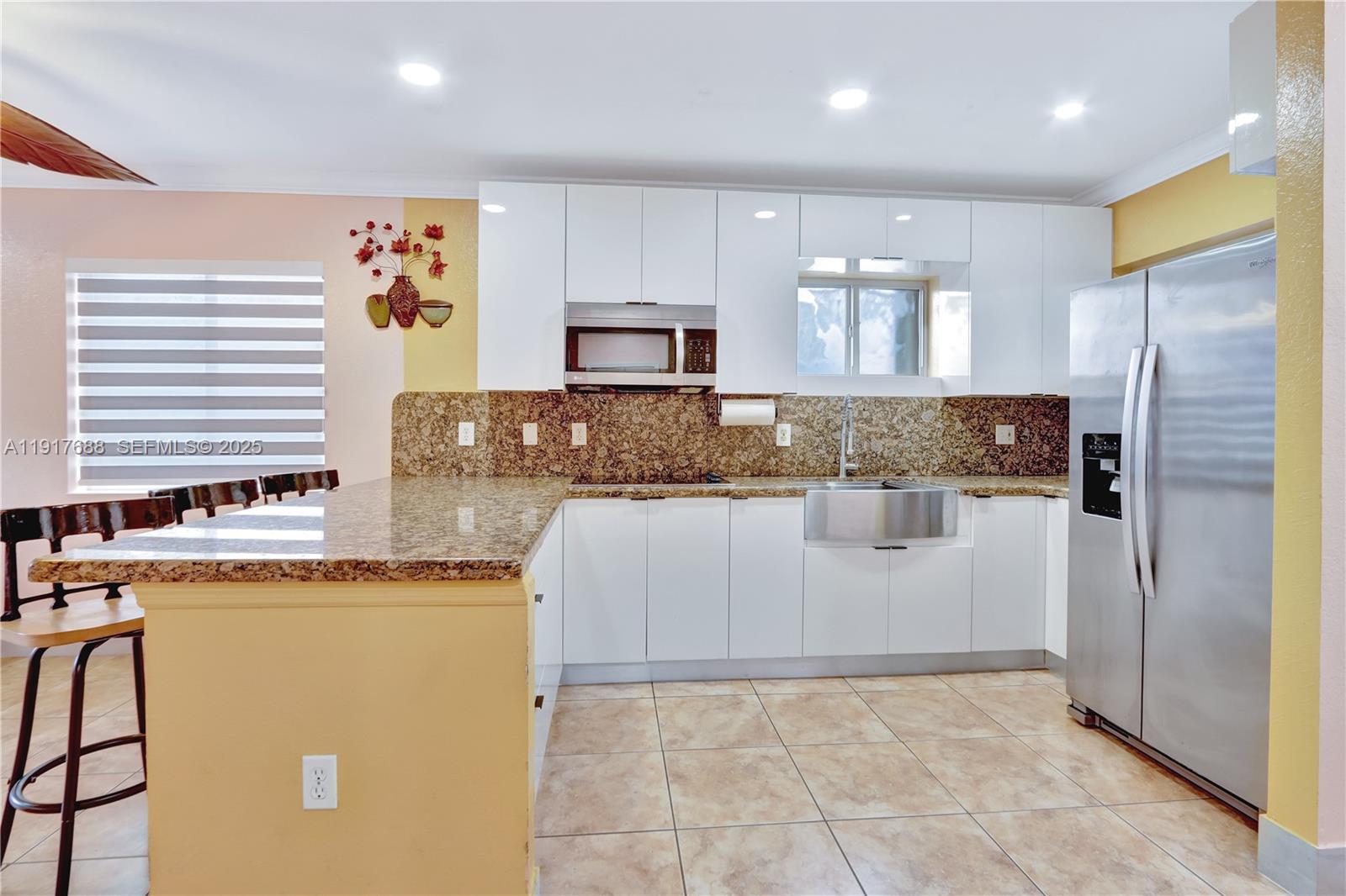 20455 Southwest 154th Avenue Miami, FL 33187 - Photo 44 of 95 a kitchen with stainless steel appliances granite countertop a refrigerator a oven and a stove
