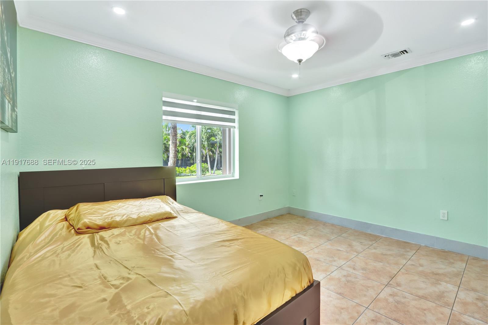 20455 Southwest 154th Avenue Miami, FL 33187 - Photo 48 of 95 a bedroom with a bed and a chandelier