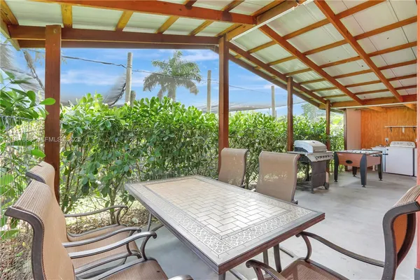 a view of a backyard with potted plants