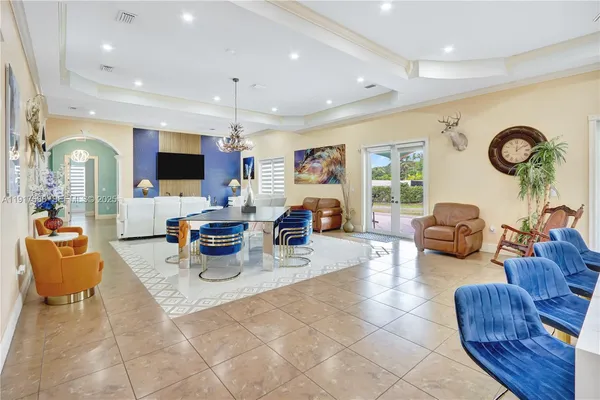 a large kitchen with stainless steel appliances kitchen island granite countertop a sink and dishwasher a stove with wooden floor