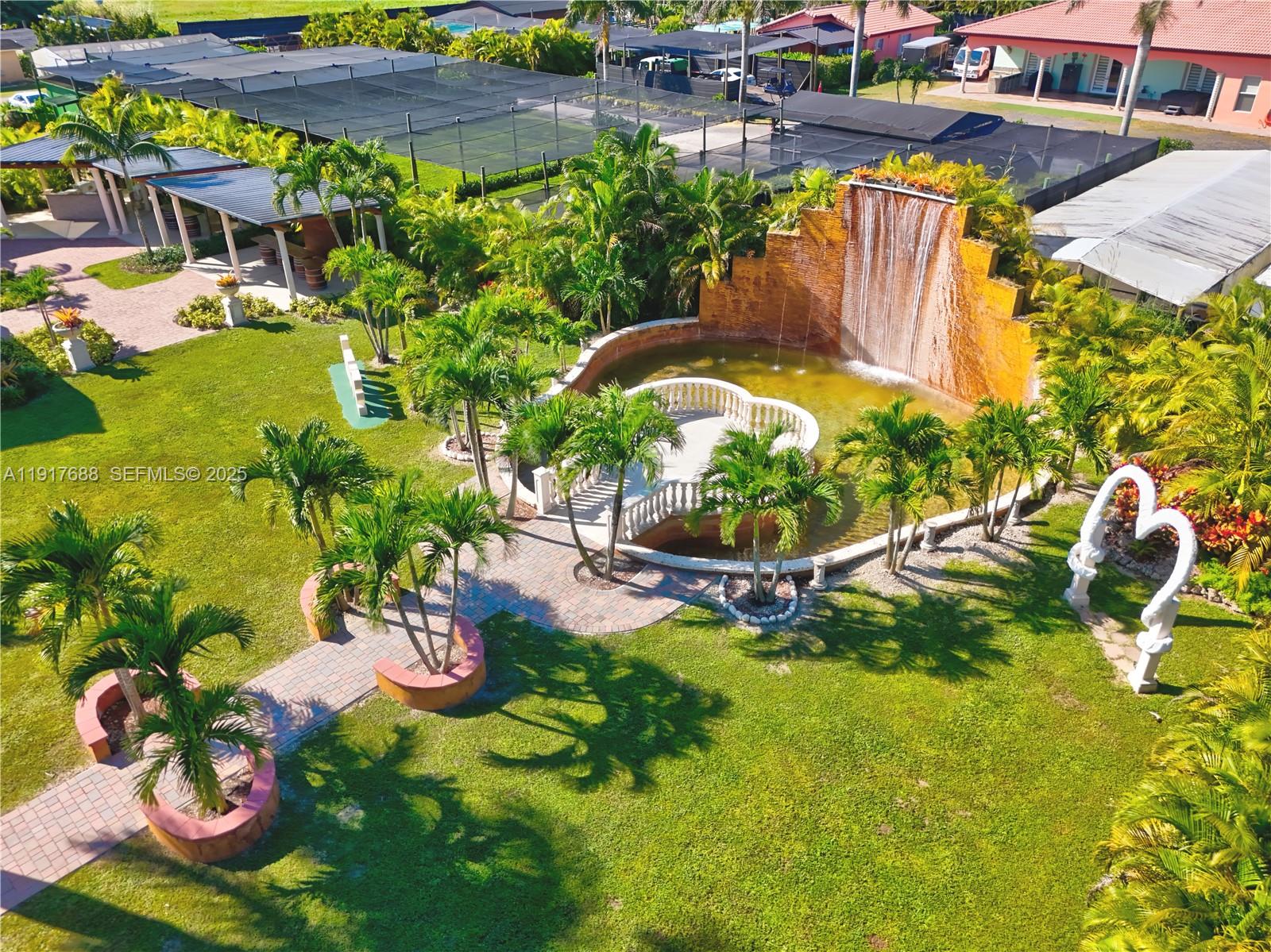 20455 Southwest 154th Avenue Miami, FL 33187 - Photo 56 of 95 a view of a swimming pool with a yard and plants