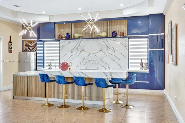 a living room with kitchen island furniture and a chandelier