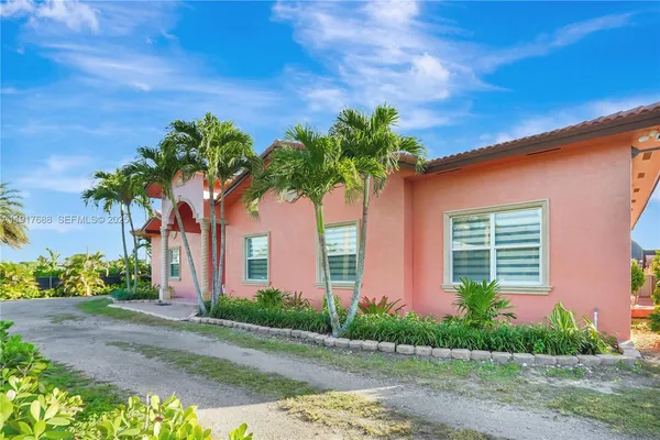 a dining room with furniture a chandelier and wooden floor