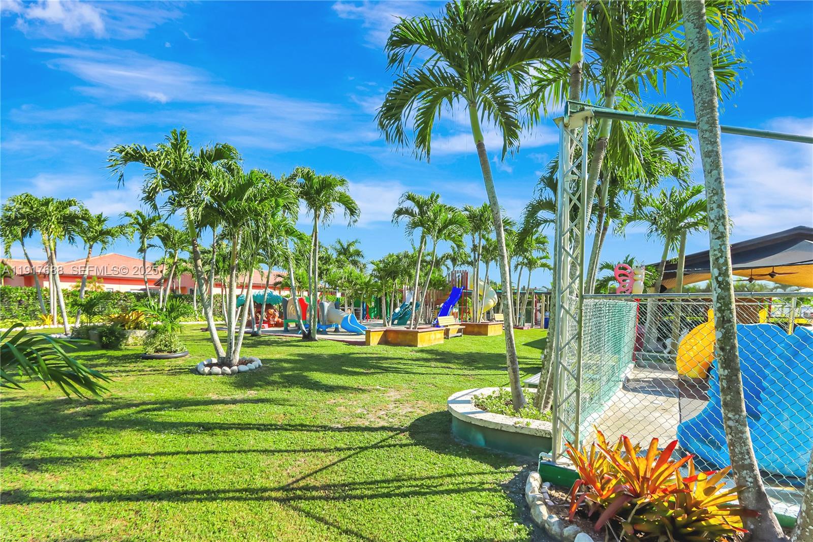 20455 Southwest 154th Avenue Miami, FL 33187 - Photo 75 of 95 a front view of a multi story residential apartment building with a yard