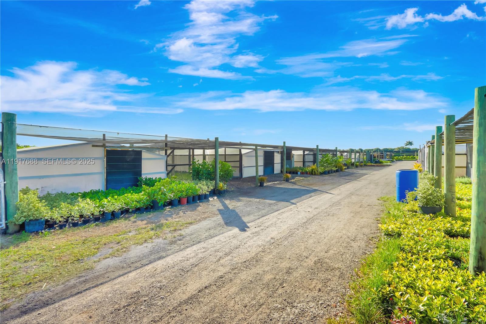 20455 Southwest 154th Avenue Miami, FL 33187 - Photo 89 of 95 a view of a garden with a building in the background