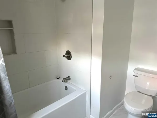 a bathroom with a toilet and a bathtub