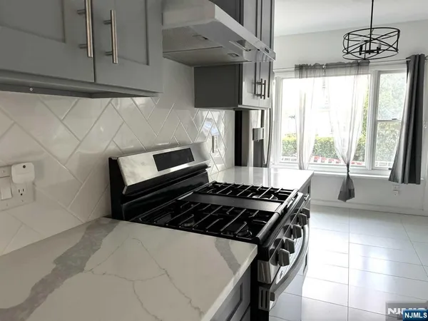 a kitchen with granite countertop a stove and a sink