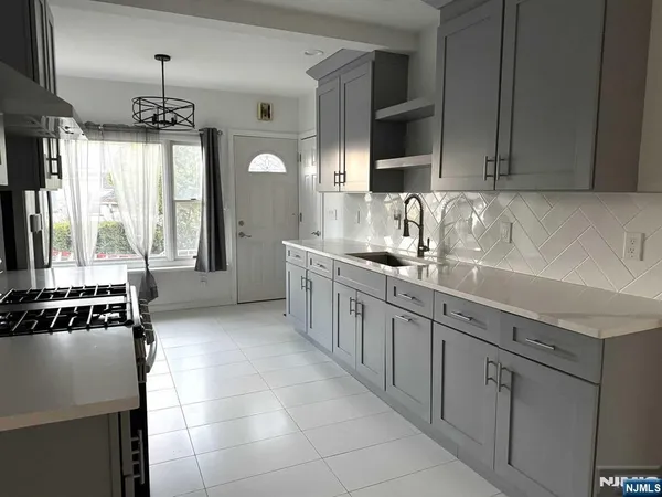 a kitchen with a sink stove and cabinets