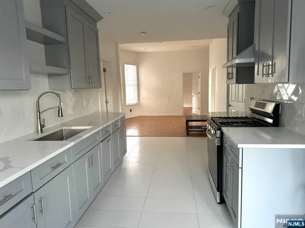 a kitchen with a sink and a stove top oven