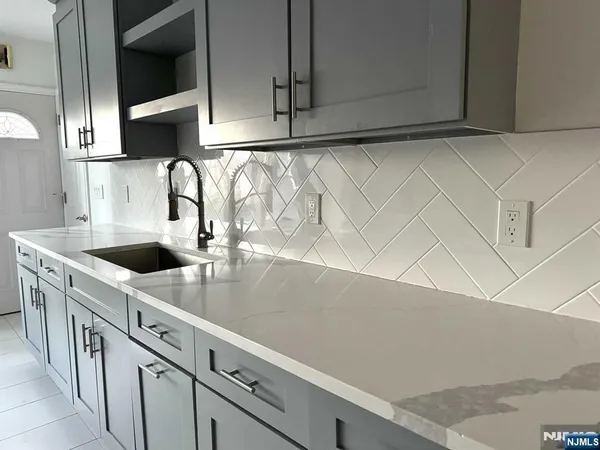 a kitchen with stainless steel appliances a sink a stove and a microwave