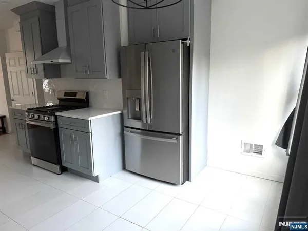 a kitchen with stainless steel appliances a refrigerator and a stove